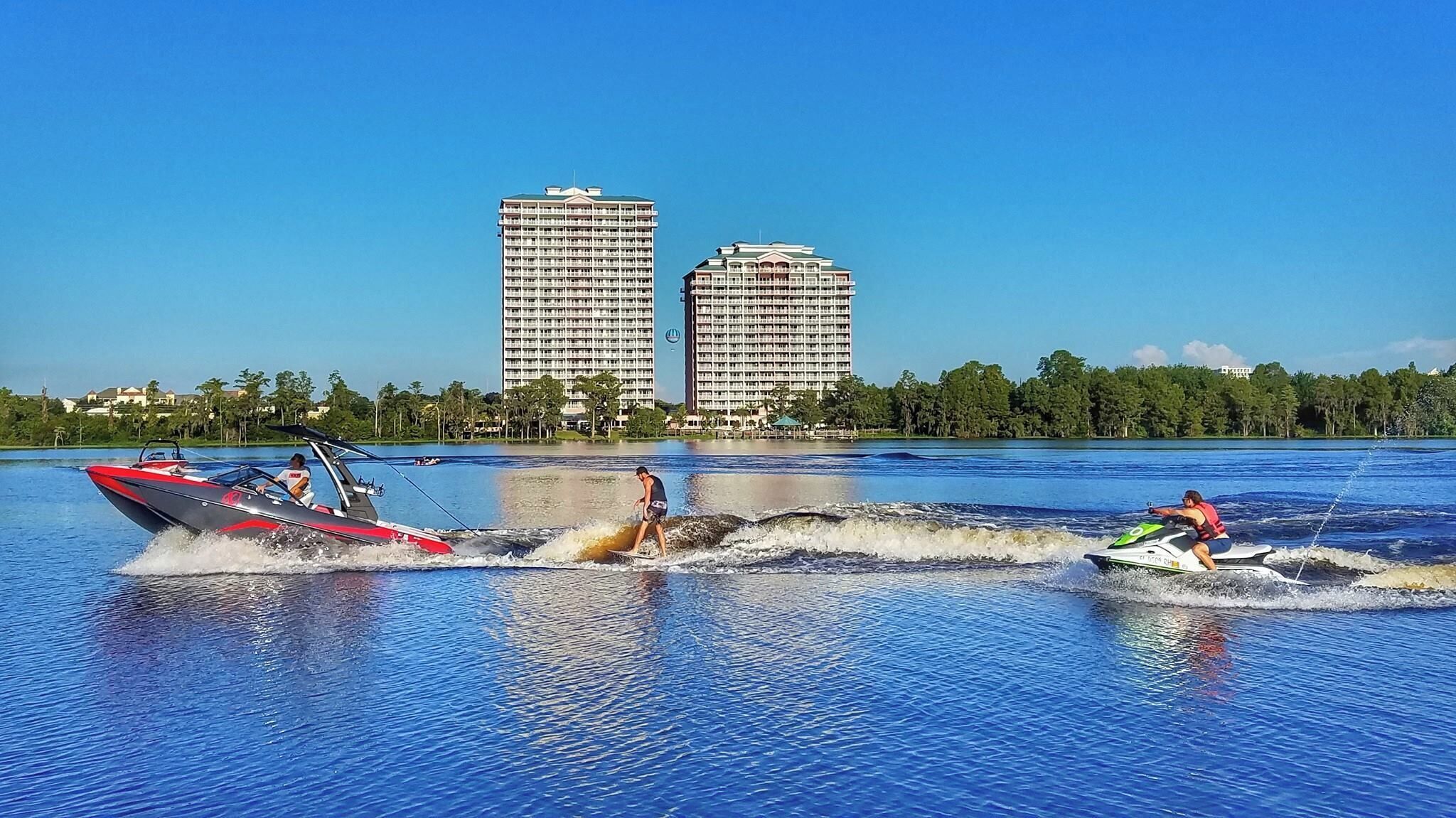 A water body with two high-rise buildings in the background.