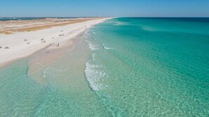 An aerial view of a beach with clear turquoise waters and a sandy shore. - Pet-Friendly Beach Retreat w Fenced Yard & Fire Pit (Navarre)