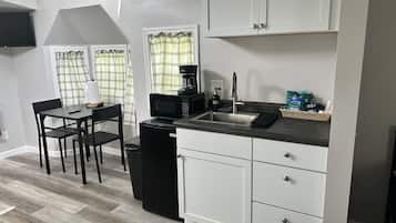 Fridge, microwave, coffee/tea maker, cookware/dishes/utensils