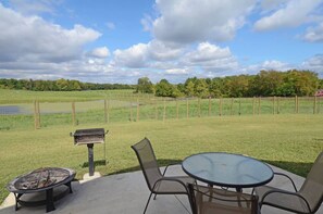 Enjoy al fresco dining and socializing on this patio with a serene view of the surrounding pasture.