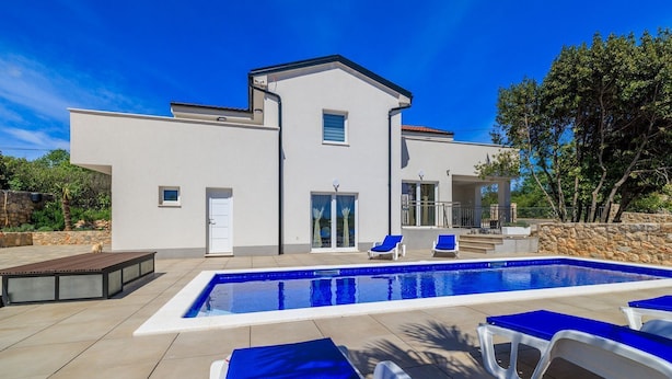 A modern two-story house with a swimming pool, outdoor seating, and a stone wall. - Large pool with salt electrolysis not far from the healing mud bay (Kras-Dobrinj)