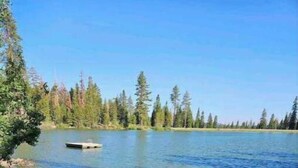 A beach with a surfboard and a kayak. - Bear Valley Alpine Cabin-3bdrm2bth (Bear Valley)