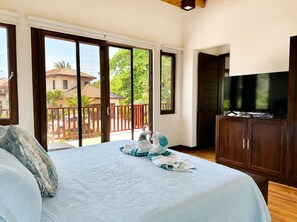 A hotel room with a bed, a television, and a view of a balcony with a railing. - Living Waters Casita  Private Pool, Camp Bay (Camp Bay)
