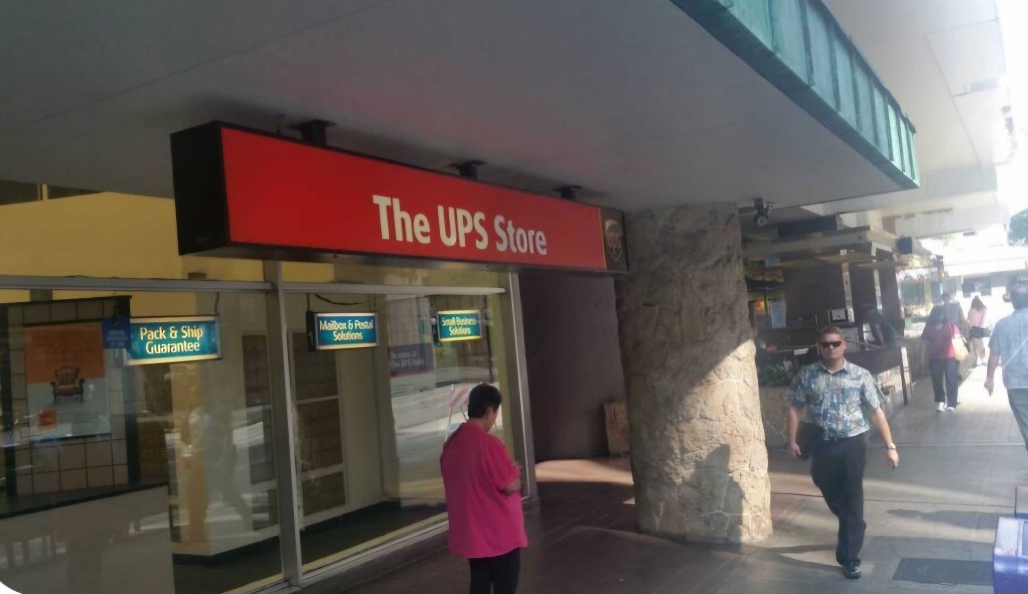 The UPS Store with a 'Pack & Ship Guarantee' sign and 'Mailbox & Postal Solutions' sign.