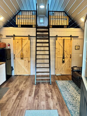Staircase leads to a cozy upper level with a space and a personal touch.
