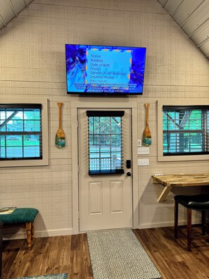 Relax in this cozy space with a large flat-screen TV and comfortable seating area.