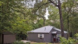 A single-story house with a sloped roof, a front door, and a small porch area.