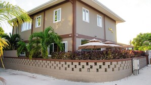 A two-story building with a beige exterior, a brick lower level, and a flat roof. - Luna lodge  (Olhuvelifushi)
