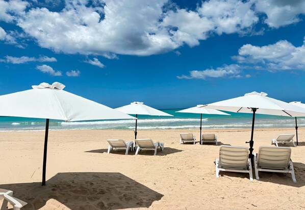 Beach nearby, white sand, sun loungers, beach umbrellas