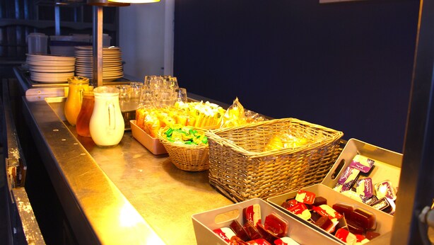 A buffet area with various food items, baskets, and glassware. - Henson Hotel (Blackpool)