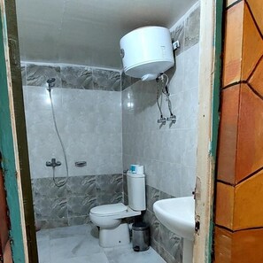 A small bathroom with a toilet, sink, and shower. - Hllol Hotel Abu Simbel (Abu Simbel)