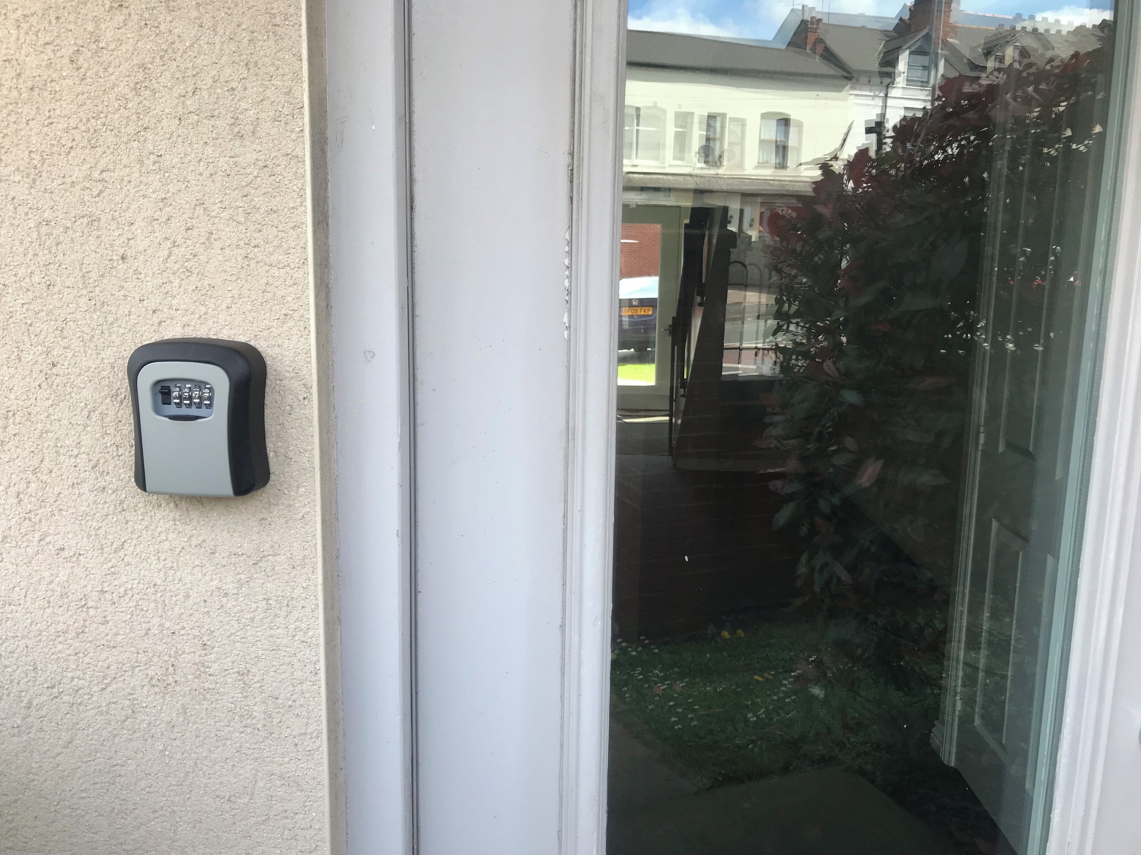 A door with a keypad lock and a glass door.