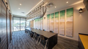 A conference room with a long table, chairs, and a large window. - Holiday Inn Express & Suites Fort Walton Beach Eglin Area by IHG (Fort Walton Beach)