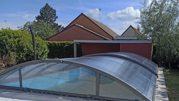 A covered carport with a curved roof.
