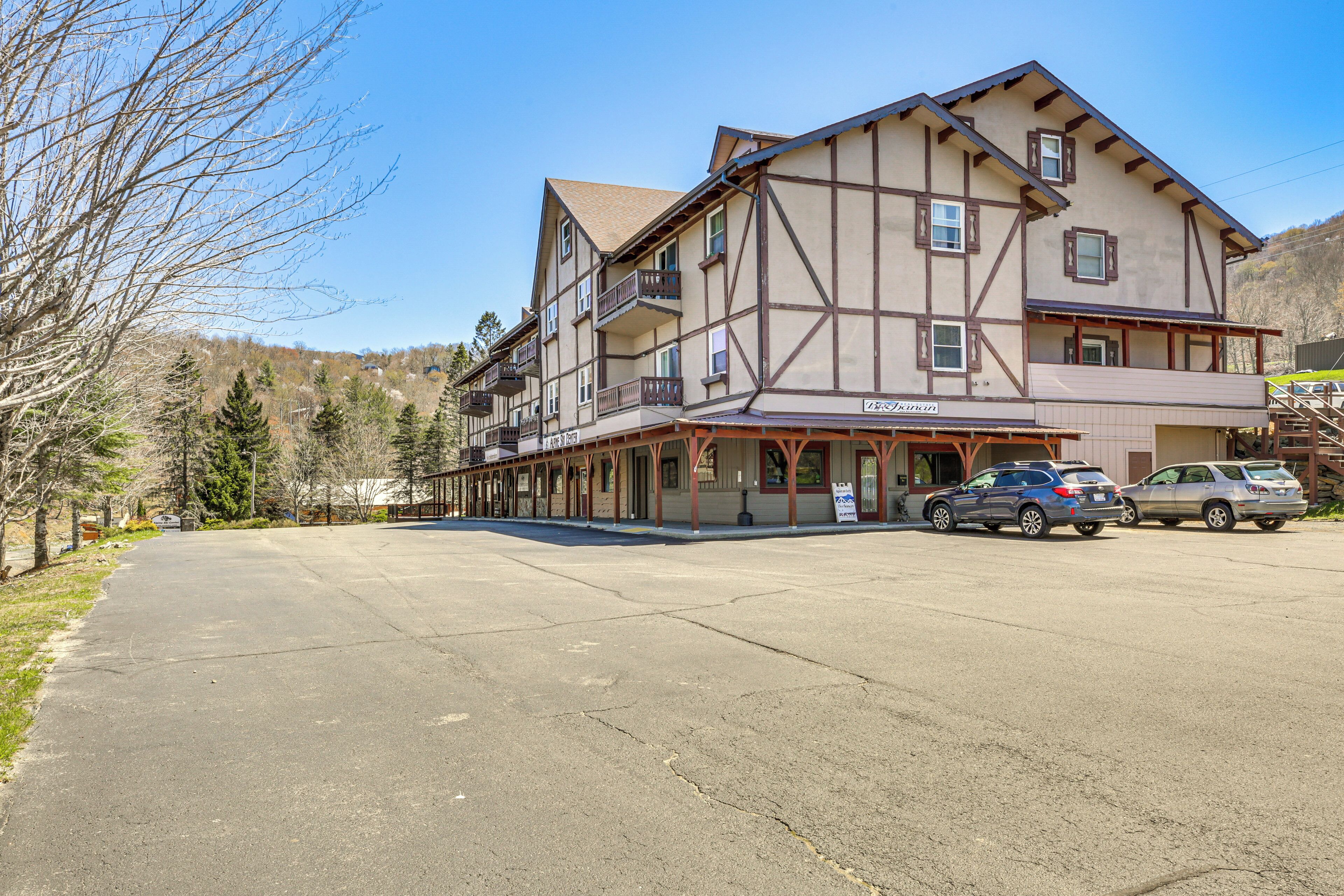 A multi-story building with a traditional architectural style, featuring a balcony on the second floor and a sign indicating it is a hotel.