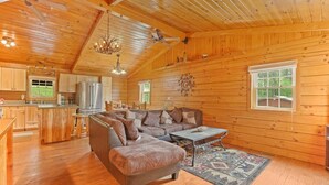 A spacious log cabin with a large living area, a kitchen, and a dining area. - Stargazing Dome Cabin W/ Hot Tub , Sauna, Firepit (Logan)