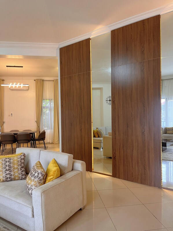 Deluxe Apartment, 3 Bedrooms, Private Bathroom | Living area | 65-inch Smart TV with cable channels