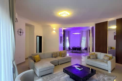Deluxe Apartment, 3 Bedrooms, Private Bathroom | Living area | 65-inch Smart TV with cable channels