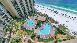 A resort with two swimming pools, a beach, and a high-rise building. - Summerhouse 1012c (Panama City Beach)