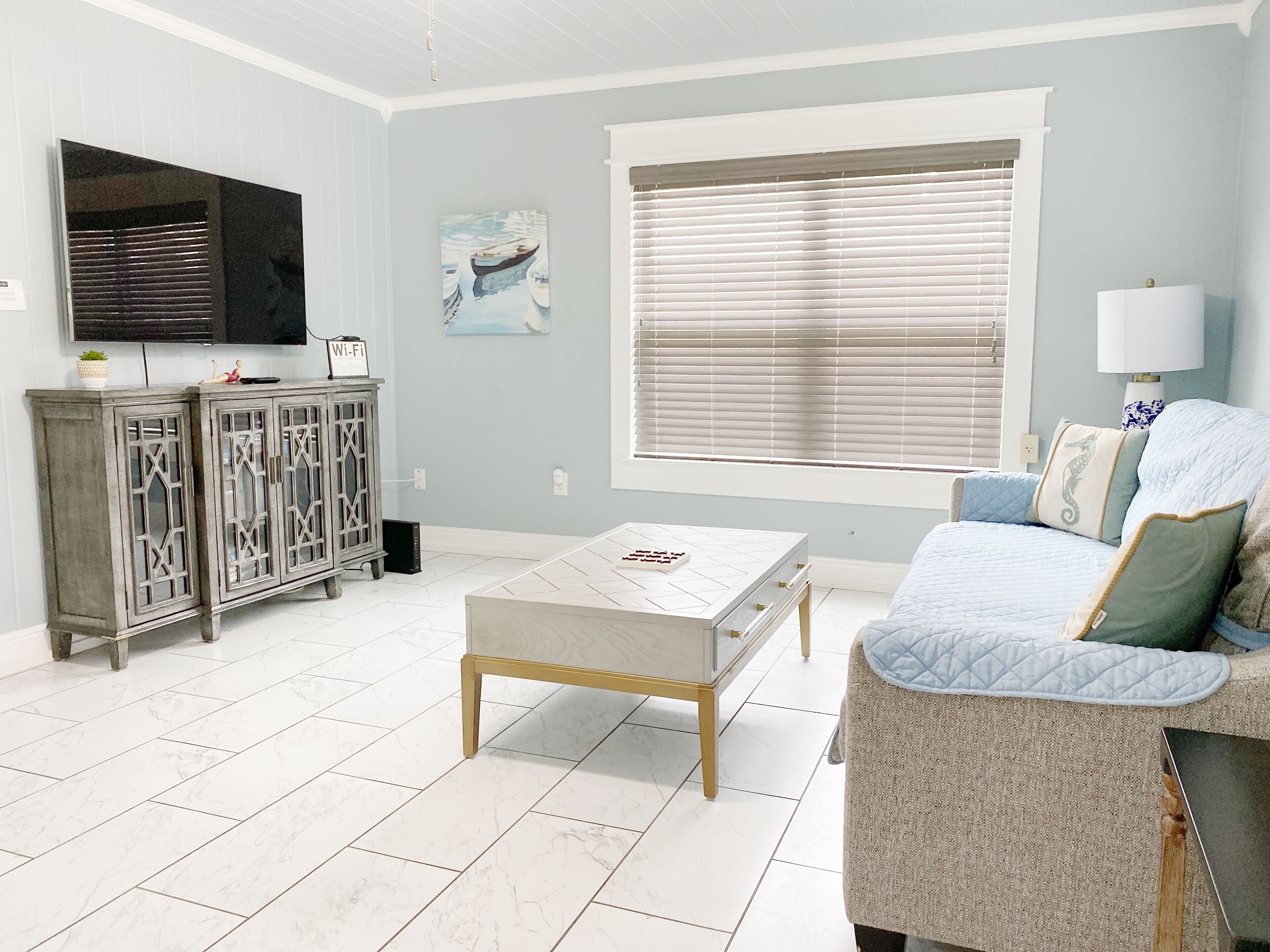 A living room with a sofa, a coffee table, and a cabinet.