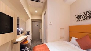 A hotel room with a bed, a desk with a chair, a television, and a door leading to a hallway. - Queens Hotel Chitose (Chitose)
