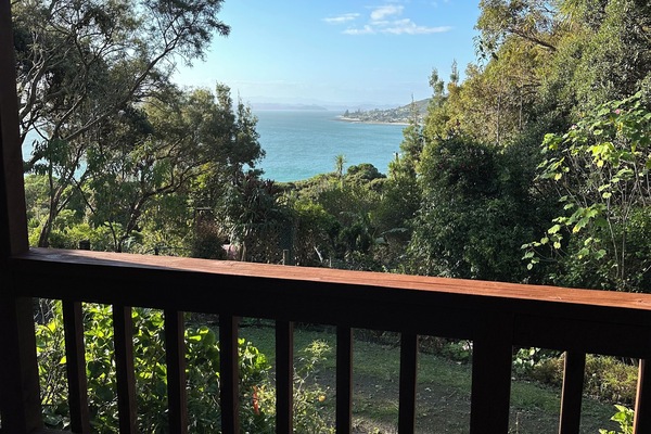 Covered deck area with seating. Gate for keeping small children and pets safe.