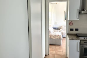 A kitchen with a stove, oven, and cabinets.