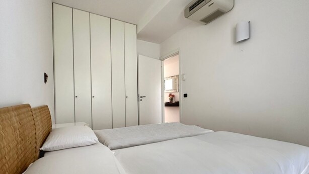 Une chambre à coucher avec un lit, une armoire et un miroir.