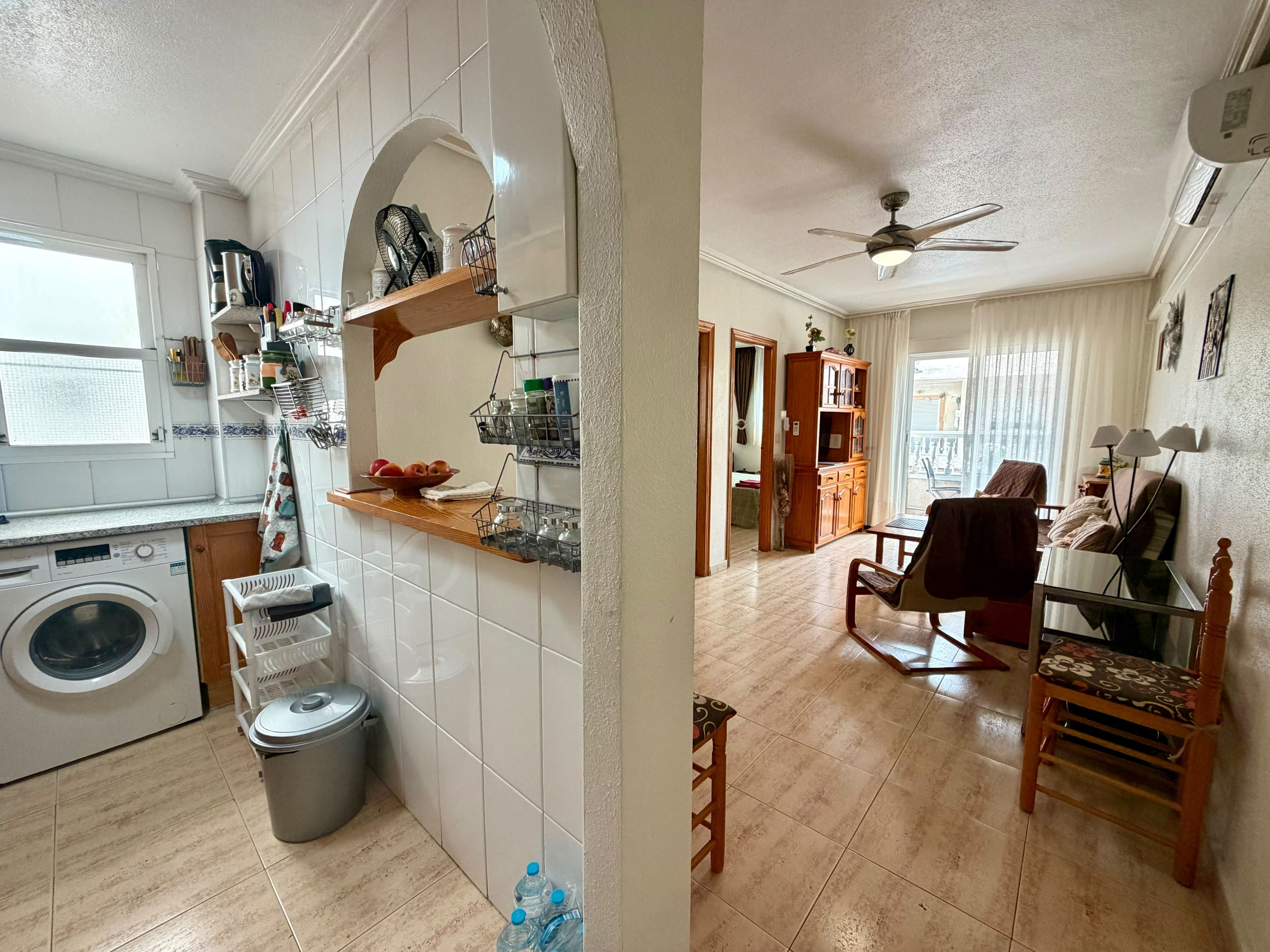 A compact living space with a kitchen, dining area, and a small seating area.