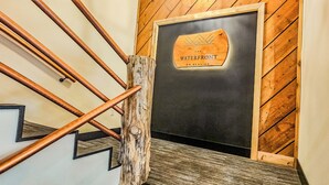 A staircase with wooden handrails and a sign that reads 'The Waterfront on Glacier.' - Waterfront on Glacier (Juneau)