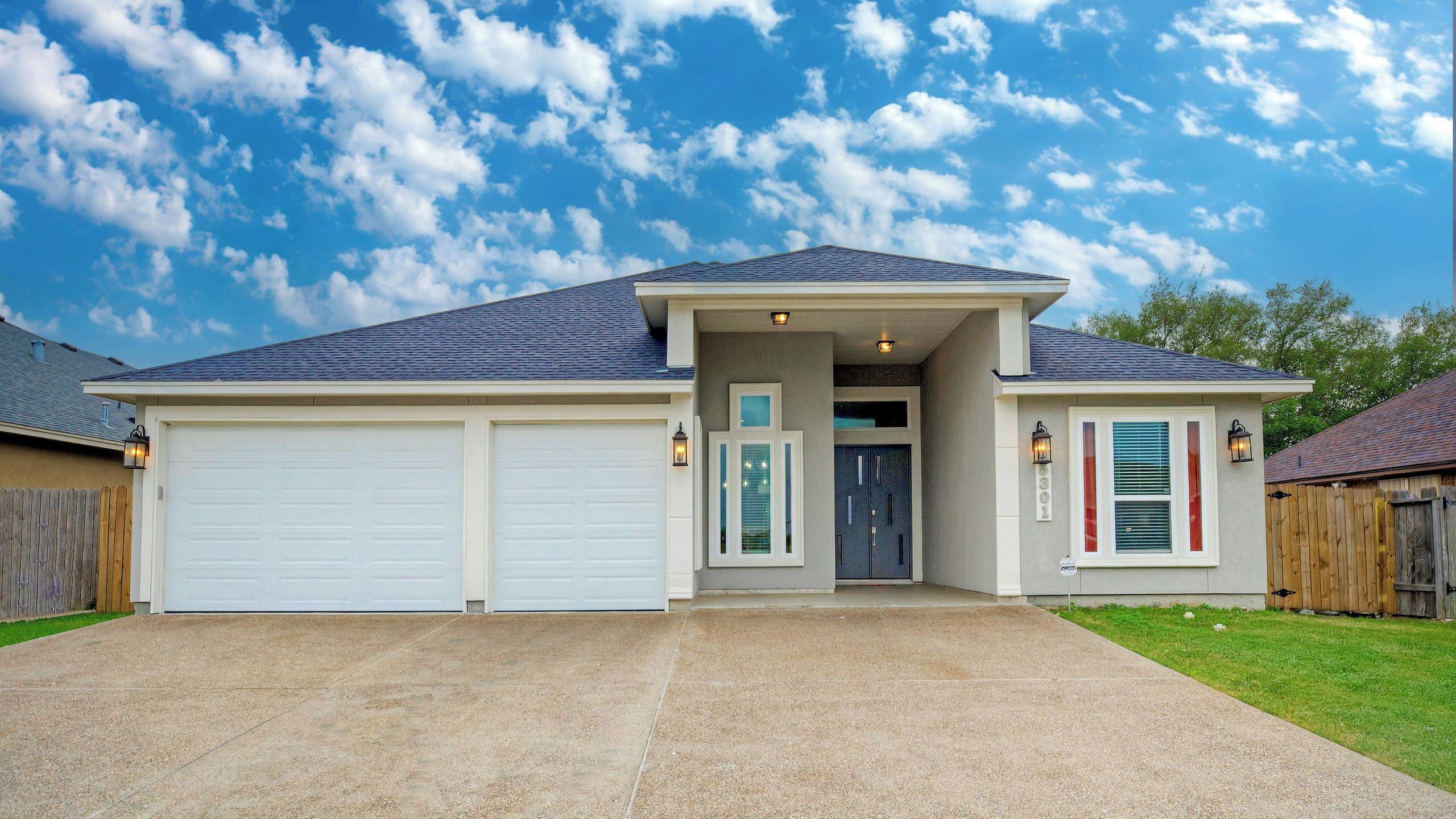 A two-story house with a garage, a front door, and a small porch area.