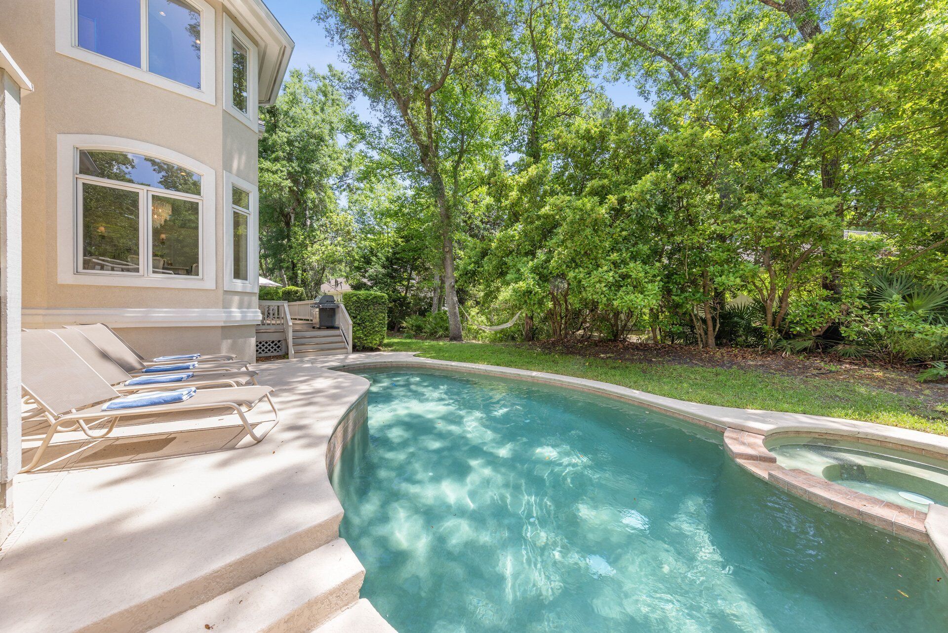 sun loungers offer the perfect spot to soak up the sun after a refreshing swim or a lively game