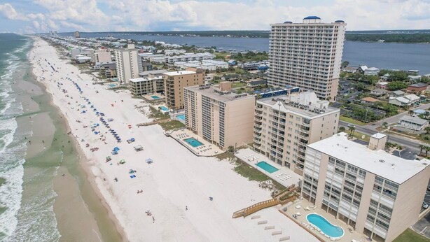 A coastal hotel with multiple buildings, a beach, and a large pool area. - BEACHFRONT CONDO, FAMILY FRIENDLY, LOW FLOOR, OUTDOOR POOL (Gulf Shores)