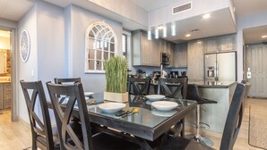 A modern kitchen with a dining area.