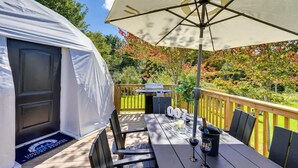 A covered outdoor area with a table, chairs, and a grill. - 007 Geodome - Unique Escapes "007" Luxury Camping Geo-Dome! (Monticello)