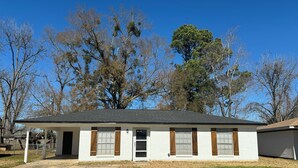 A single-story house with a front porch, a garage, and a lawn. - A Home Away From Home - Rest, Relax, & Enjoy (Alexandria)