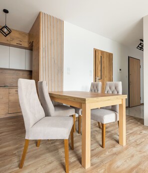 Enjoy meals in this dining area with a wooden table and four comfortable chairs.