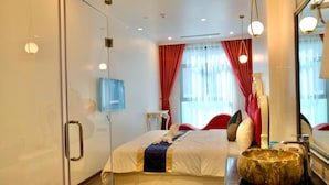 A modern hotel room with a large bed, a vanity with a mirror, a red curtain, and a large window. - Royal Hotel Thanh Tri (Hanoi)