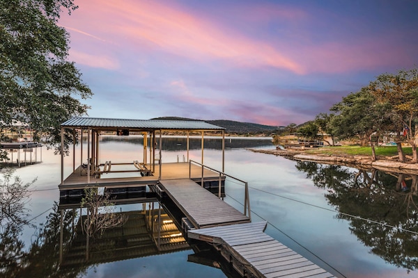 Serene lakeside dock perfect for boating and sunset views.