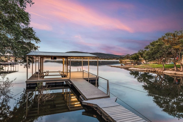 Serene lakeside dock perfect for boating and sunset views.