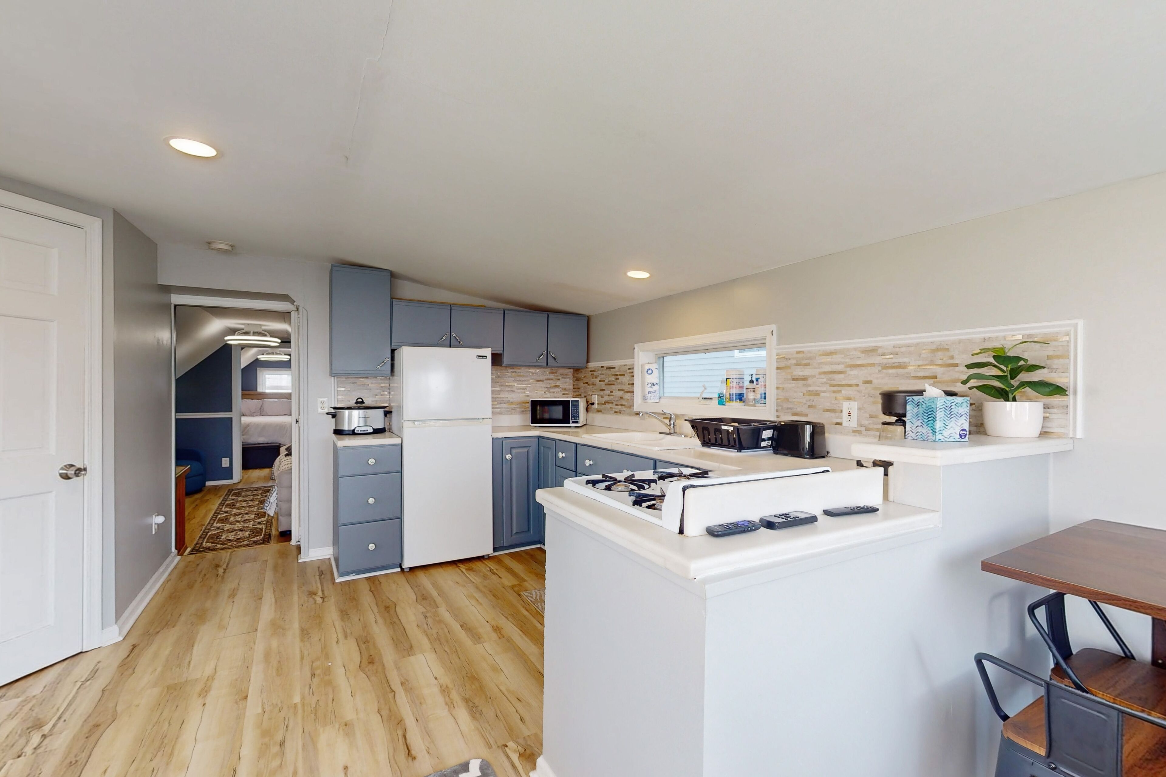 Charming escape with furnished patio, shared grill, full kitchen, & AC