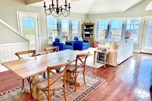 Enjoy a comfortable stay in this inviting space with a dining area, cozy seating, and a bookshelf.