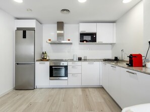 Enjoy cooking in this well-equipped kitchen with an oven, microwave, and refrigerator.