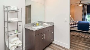 A modern bathroom with a vanity, a towel rack, and a mirror. - Rebel Run at 514 by Apex Short Term Stays (Oxford)