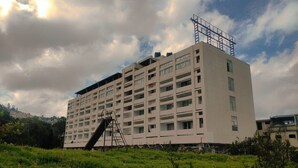 A multi-story building with a central staircase and a flat roof. - Nachiappa Palaniappa Grand Inn (Kodaikanal)