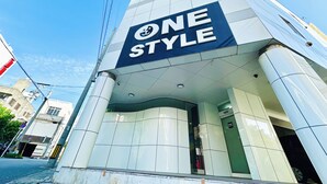 A modern building with a prominent 'ONE STYLE' sign. - ONE STYLE (Naha)