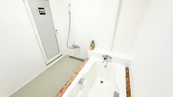 A bathroom with a shower, a sink, and a toilet.