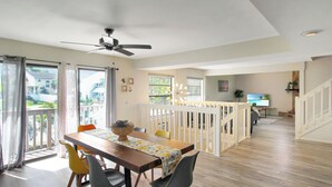 A dining area with a wooden table, chairs, and a ceiling fan. - Two Story Private Pool Home Near Bradenton Beach Bayside Paradise (Bradenton)