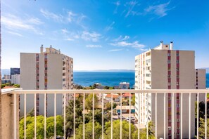 A view of two multi-story buildings with balconies, overlooking a body of water and a clear sky. - City Seaview Apartment Vigo (Rijeka)