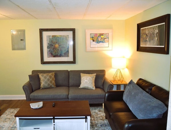 Relax in this inviting living room with a sofa, armchair, and coffee table.